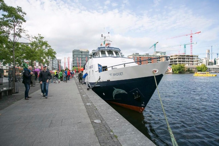 Dublin Bay Cruise picks up passengers during the Docklands Summer Festival. The first time in living memory a boat of this size has worked commercially in the Grand Canal Basin.